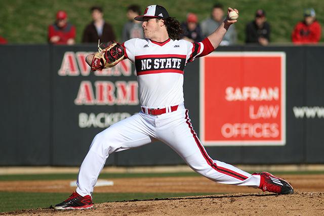 Junior pitcher Ryan Williamson lunges out on the mound as he delivers a pitch in the Wolfpack's 8-10 loss to Wright State on February 26, 2016. Williamson struck out 6 batters in 4.0 innings pitched and allowed 6 hits and allowed 4 earned runs in the loss at Doak Field.