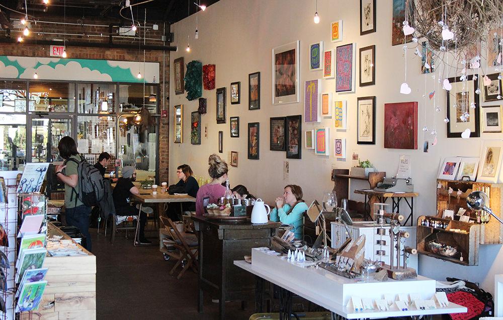 Customers sit surrounded by handmade artwork in Lucky Tree Gallery &amp; Caf&#233; in 2018. Opened in 2015, Lucky Tree supports over 50 local artists and sources their coffee from roasters in Durham, NC and milk from NC State's Howling Cow. Their menu is completely wheat free and many items are vegan friendly.
