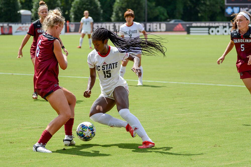 NC State sophomore Jameese Joseph (15) moves past a defender during the NC State Wolfpack's game against the South Carolina Gamecocks at Dail Soccer Field on Sunday, August 29, 2021. The Wolfpack lost the match 2-1 on a last-minute score by the Gamecocks. Joseph scored the only goal for the Wolfpack in the opening minutes of the first half.