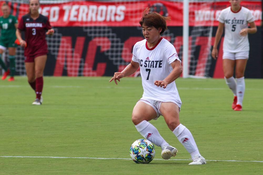 NC State freshman Emika Kawagishi dribbles through the midfield during the NC State Wolfpack's soccer match against the South Carolina Gamecocks at the Dail Soccer Field on Saturday, August 29, 2021. The Wolfpack lost the match 2-1 on a last-minute score by the Gamecocks.