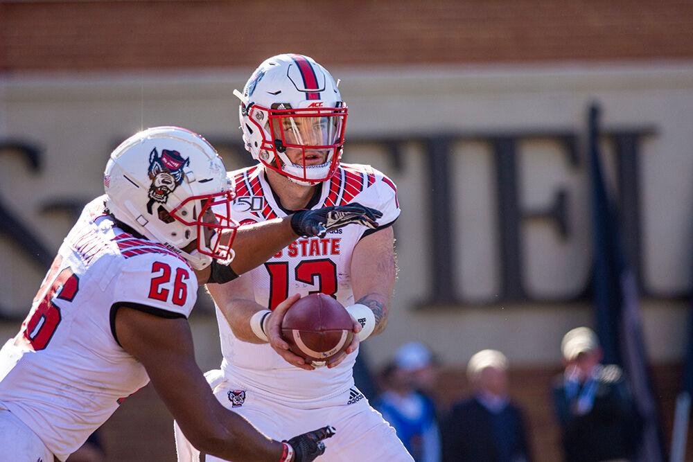 Redshirt freshman quarterback Devin Leary hands the ball off to redshirt freshman running back Trent Pennix versus Wake Forest on Saturday, Nov. 2, 2019 at BB&amp;T field. Leary had 17 completions in 45 attempts. The Wolfpack lost 44-10.