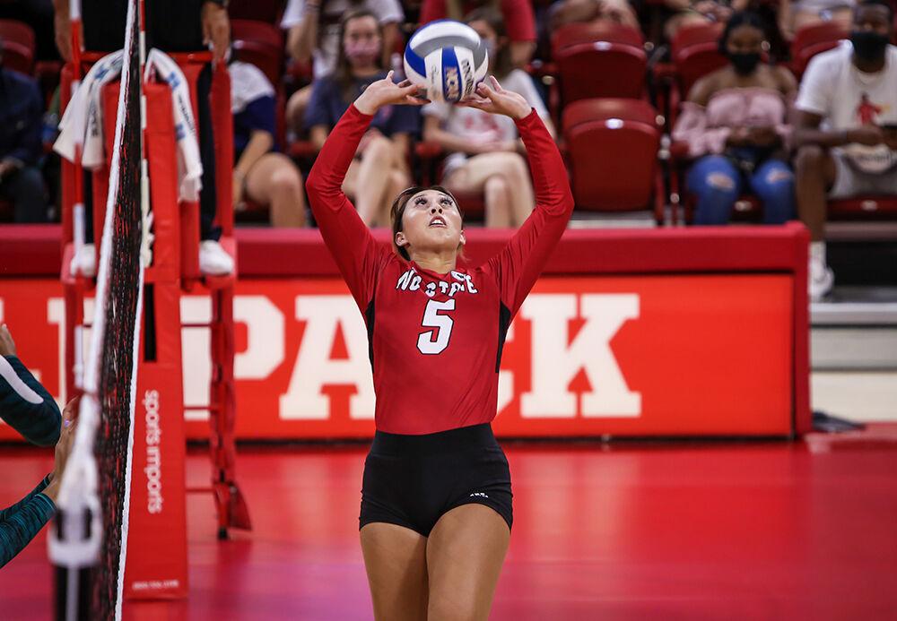 NC State junior Kristen McDaniel (5) sets the ball during the Wolfpack's exhibition game against the Coastal Carolina Chanticleers in Reynolds Coliseum on Saturday, August 21, 2021. Coastal Carolina defeated the Wolfpack 3-1 in the exhibition match, their first match of the season.
