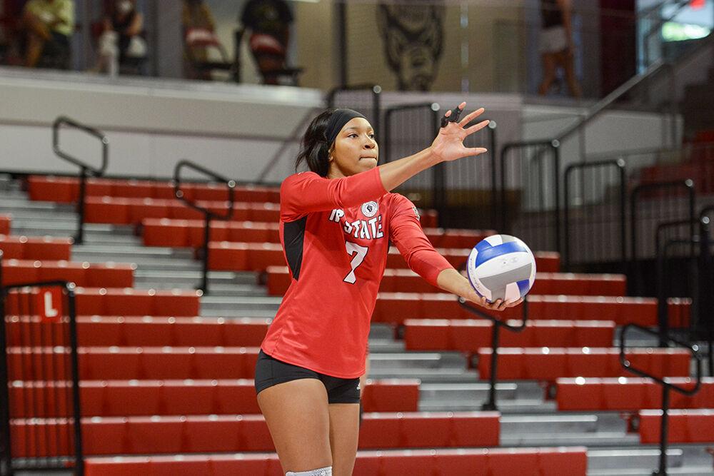 NC State senior Pam Chukwujekwu (7) prepares to serve against the Coastal Carolina Chanticleers in the first exhibition match of the season in Reynolds Coliseum on Saturday, August 21, 2021. The Chanticleers won the match 3-1.