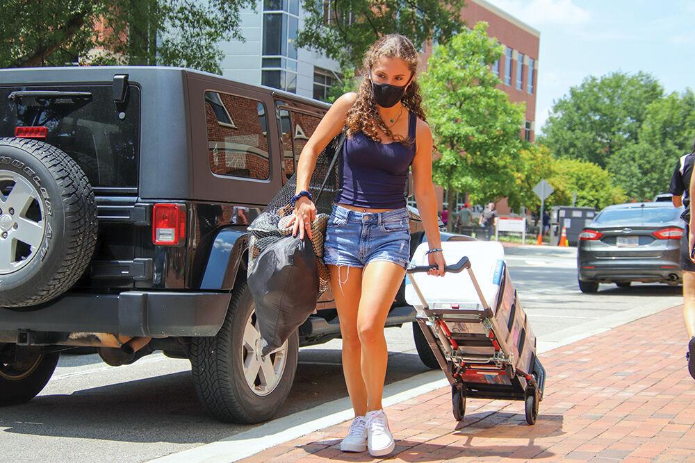 Brenna Russak, a freshman in the exploratory studies program, rolls her dorm luggage to Owen Residence Hall during move in day Aug. 12. NCSU Move-In was from Aug. 12-15.