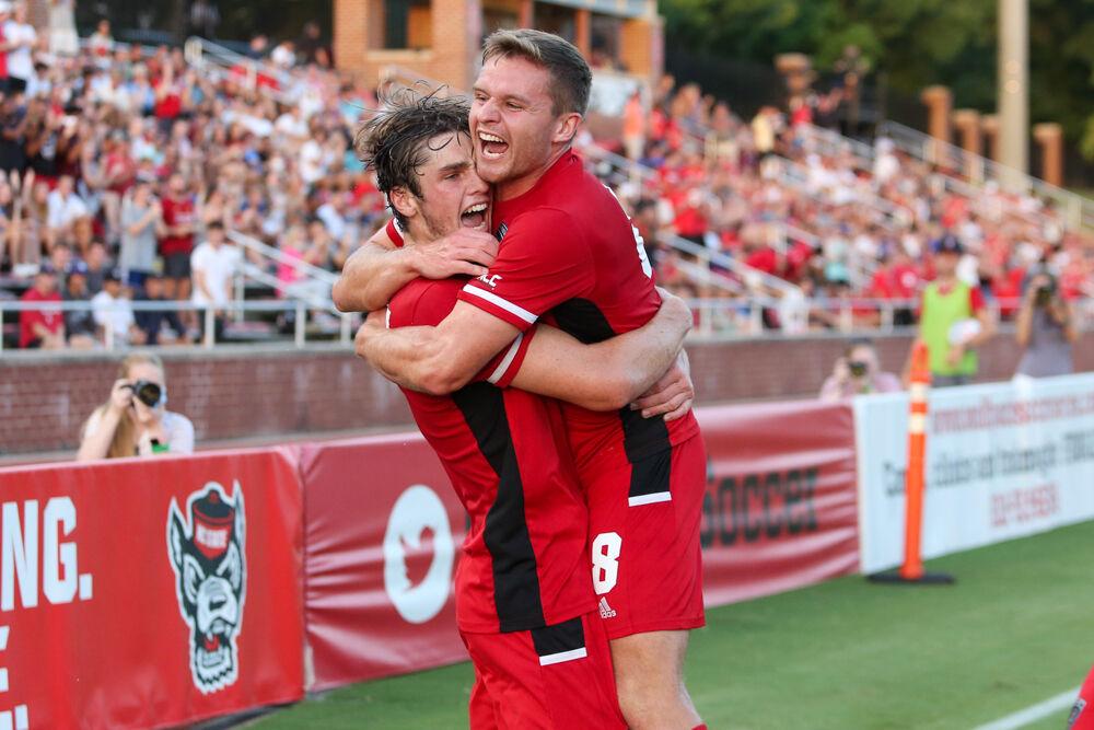 Graduate midfielder Brad Sweeney jumps into the arms of freshman midfielder Luke Hille after the first goal in the game. Hille scored twice in the 4-0 win over UNC Asheville on Monday, Aug. 30, 2021.