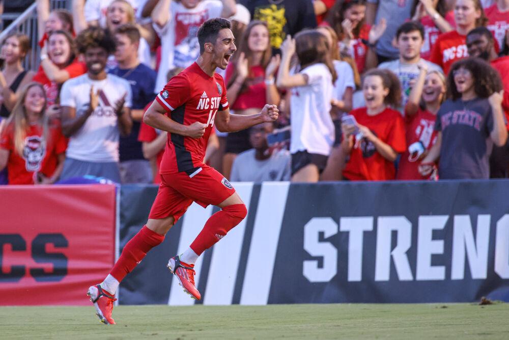 Freshman forward Henrique Santos runs past the fans after scoring a goal in the 4-0 win over UNC Asheville on Monday, Aug. 30, 2021.