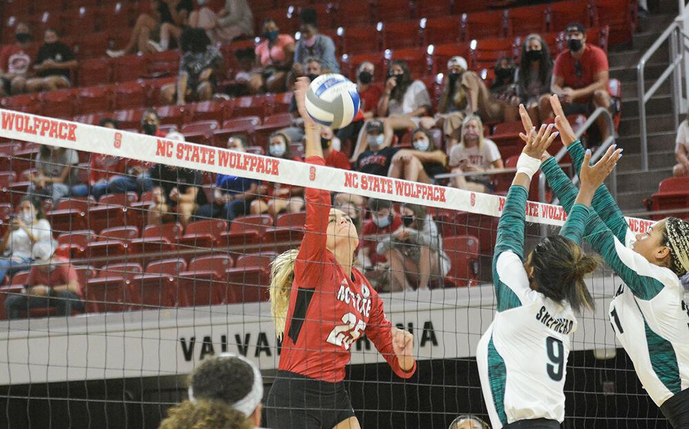 NC State sophomore Riley Shaak (25) jumps to take a shot against the Coastal Carolina Chanticleers in the first exhibition match of the season in Reynolds Coliseum on Saturday, August 21, 2021. The Chanticleers won the match 3-1.