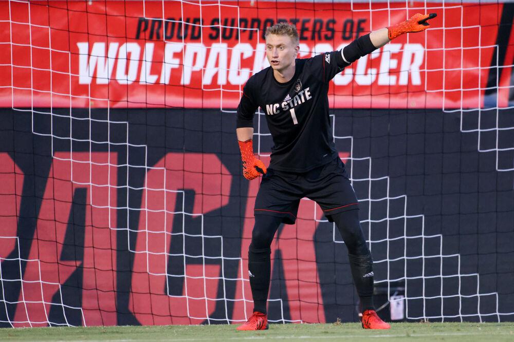 Redhsirt senior keeper Leon Kampf points out a player making a run on the backside during the 4-0 win over UNC Asheville on Monday, Aug. 30, 2021.