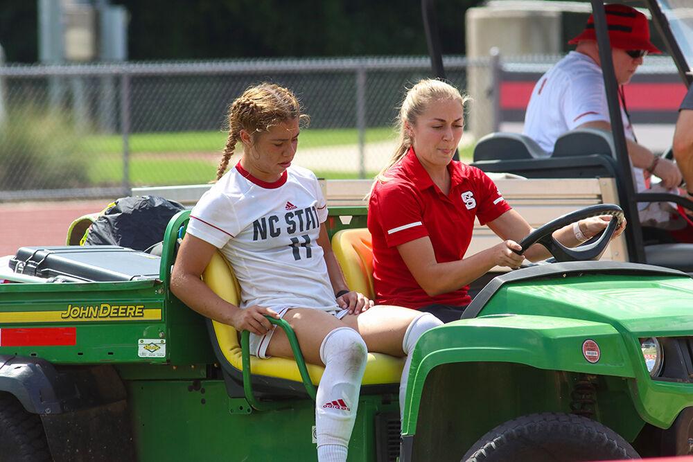 NC State freshman Fernanda Soto is carted off the field following an ankle injury during the NC State Wolfpack's soccer match against the South Carolina Gamecocks at the Dail Soccer Field on Saturday, August 29, 2021. The Wolfpack lost the match 2-1 on a last-minute score by the Gamecocks.