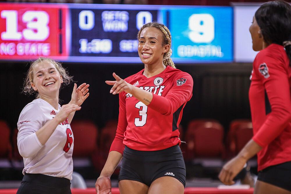 NC State graduate student Melissa Evans (3) points out a good pass from a teammate after notching a kill during the Wolfpack's exhibition game against the Coastal Carolina Chanticleers in Reynolds Coliseum on Saturday, August 21, 2021. Coastal Carolina defeated the Wolfpack 3-1 in the exhibition match, their first match of the season.