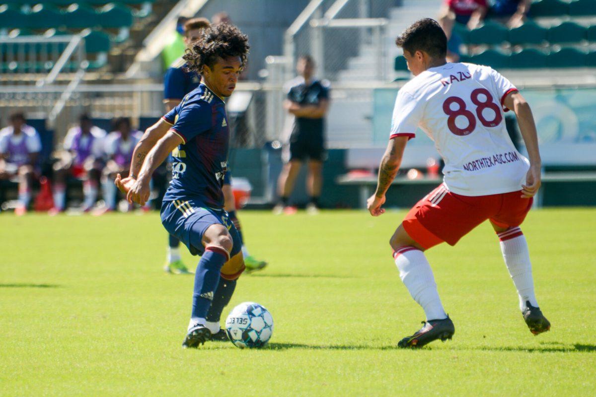 North Carolina FC forward Aziel Jackson attempts to evade North Texas SC defender Kazu during the game on Sunday, Sept. 26, 2021 at Sahlen's Stadium in WakeMed Soccer Park. Jackson had one shot on target during NCFC's 1-0 loss against North Texas SC.