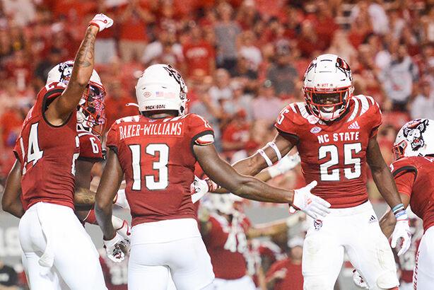 Junior nickelback Tyler Baker Williams, graduate student cornerback Derrek Pitts Jr., and redshirt freshman cornerback Shyheim Battle celebrate Baker-Williams' interception during the game against Furman on Saturday, Sept. 18, 2021 at Carter-Finley Stadium. Baker-Williams gained seven yards on the play. The Wolfpack beat the Furman Paladins 45-7.