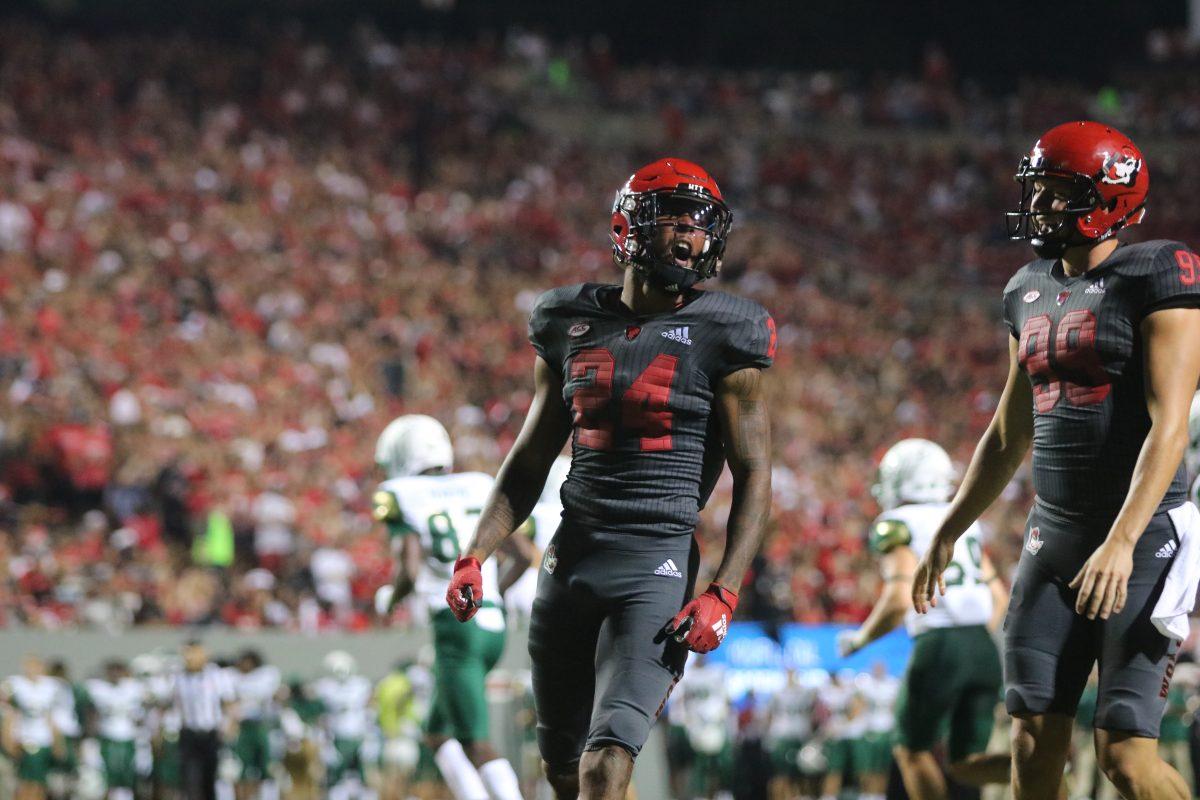 Graduate student cornerback Derek Pitts Jr. and redshirt junior punter Trenton Gill celebrate shutting down the South Florida offensive during the Wolfpack&#8217;s game against the Bulls at Carter-Finley Stadium on Thursday, Sept. 2, 2021. Pitts had 3 tackles and 1 TFL throughout the game. The Wolfpack beat the Bulls 45-0.