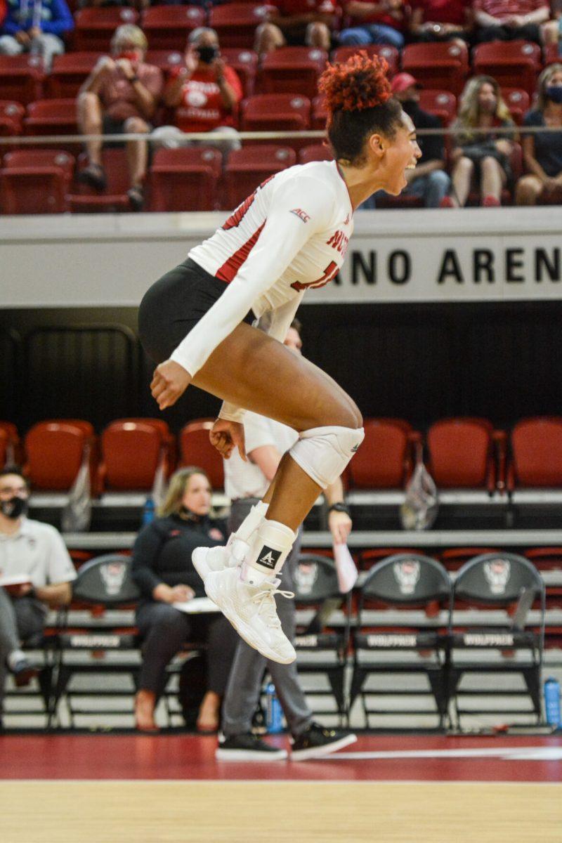 Senior outside hitter Jade Parchment jumps in celebration during the match on Thursday, Sept. 16, 2021 in Reynolds Coliseum against the Georgia Bulldogs. Parchment had 23 kills during NC State's 3-1 win over the Bulldogs.