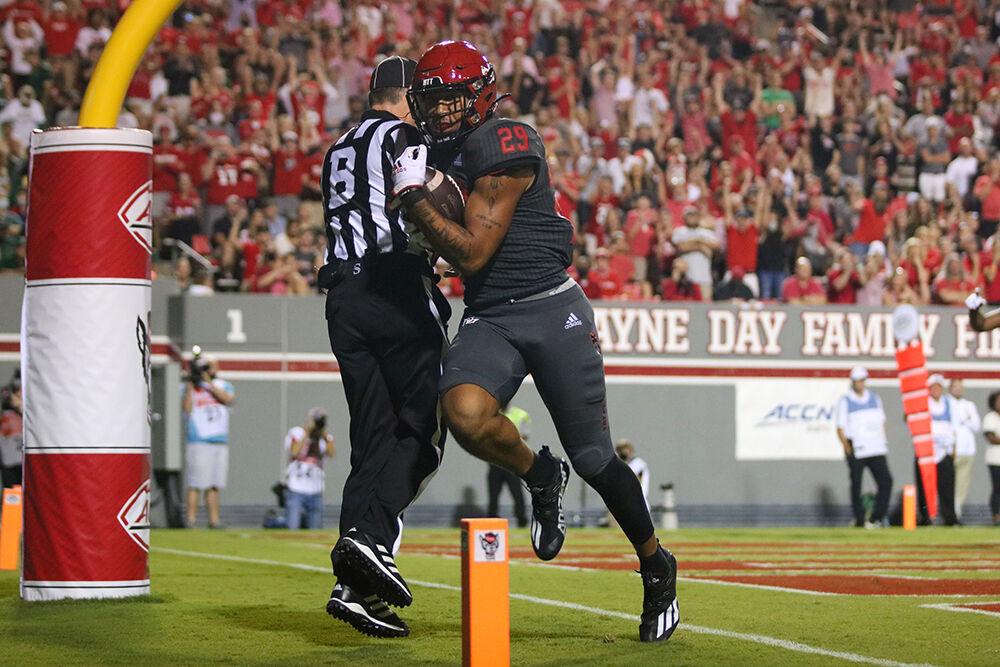 Freshman tightend Christopher Toudle runs through the end zone after scoring a touchdown during the NC State Woflpack game against the South Flordia Bulls at Carter-Finley Stadium on Thursday, Sept. 2. Toudle had 2 carries totaling 22 rushing yards with one resulting in a touchdown. The Wolfpack beat the Bulls 45-0.