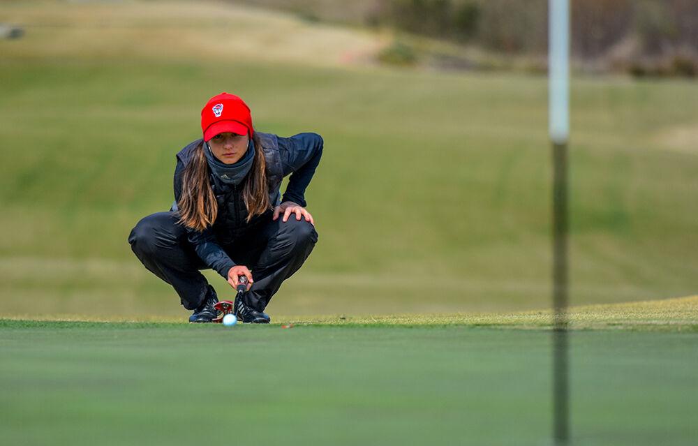 Sophomore Pilar Berchot measures the distance for her putt on Saturday, March 20, 2021 at Lonnie Poole Golf Course. Berchot finished with an individual stroke play score of (90, +18).