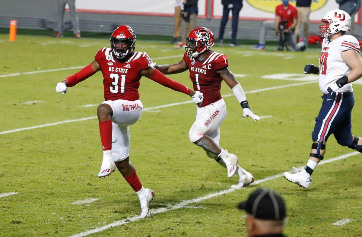 N.C. State&#8217;s Vi Jones (31) and Isaiah Moore (1) celebrate after Jones blocked the field goal attempt by Liberty&#8217;s Alex Barbir (95) during the second half of N.C. State&#8217;s 15-14 victory over Liberty at Carter-Finley Stadium in Raleigh, N.C., Saturday, Nov. 21, 2020.