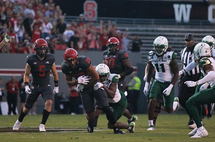 Freshman wide receiver Christopher Toudle runs the ball down the field against the South Florida defense during the NC State Wolfpack game at Carter-Finley Stadium on Thursday, Sept. 2. Toudle had 2 carries totaling 22 rushing yards with one resulting in a touchdown. The Wolfpack beat the Bulls 45-0.