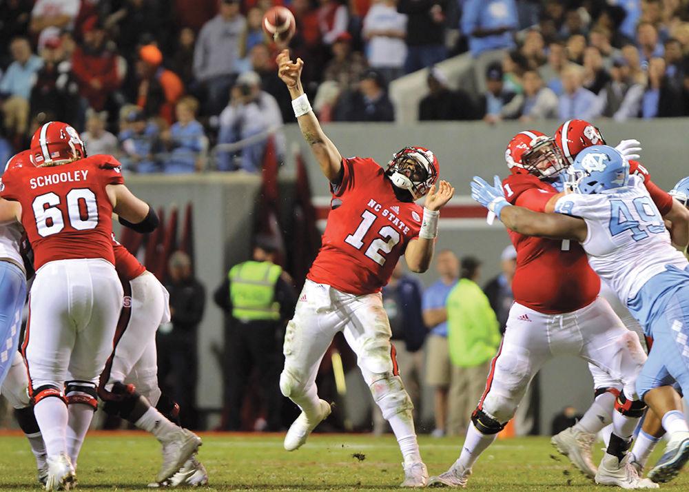 Redshirt senior quarterback Jacoby Brissett hurls a pass downfield against the Tar Heels at Carter-Finley Stadium on Nov. 28, 2015. Brissett completed 17 of 37 passes for 206 yards in the game. The Wolfpack fell to the Tar Heels 45-34.