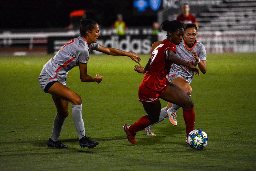 Sophomore foward Jameese Joseph dribbles through two Clemson defenders in the Wolfpack's game against the Tigers on Thursday, Sept. 23, 2021 at Dail Soccer Stadium. Jameese had one shot during NC State's 2-1 loss to Clemson.