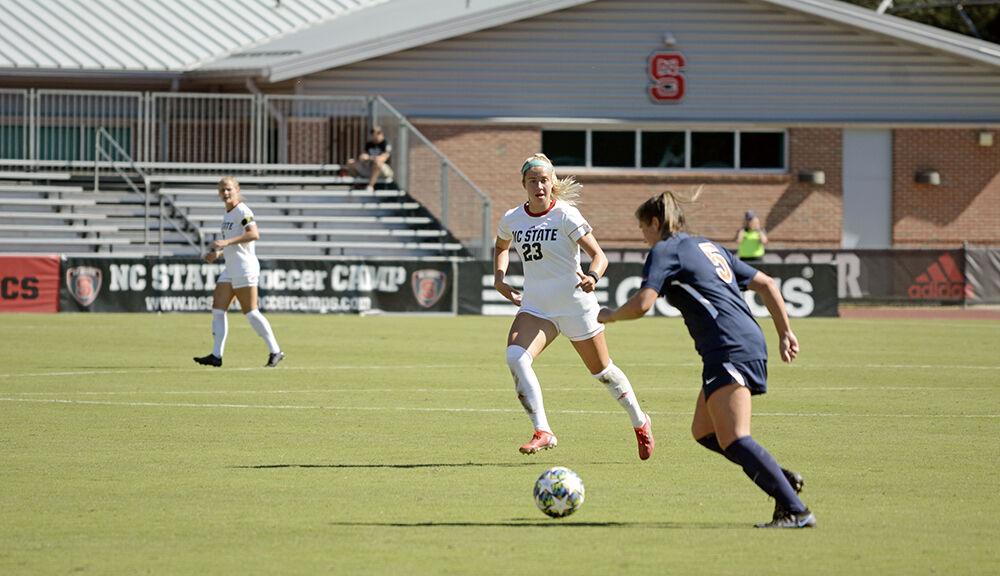 Freshman defender Cara Elmendorf defends a Virginia player on Sunday, Sept. 26, 2021 at Dail Soccer Field. NC State lost to Virginia with a final score of 2-1.