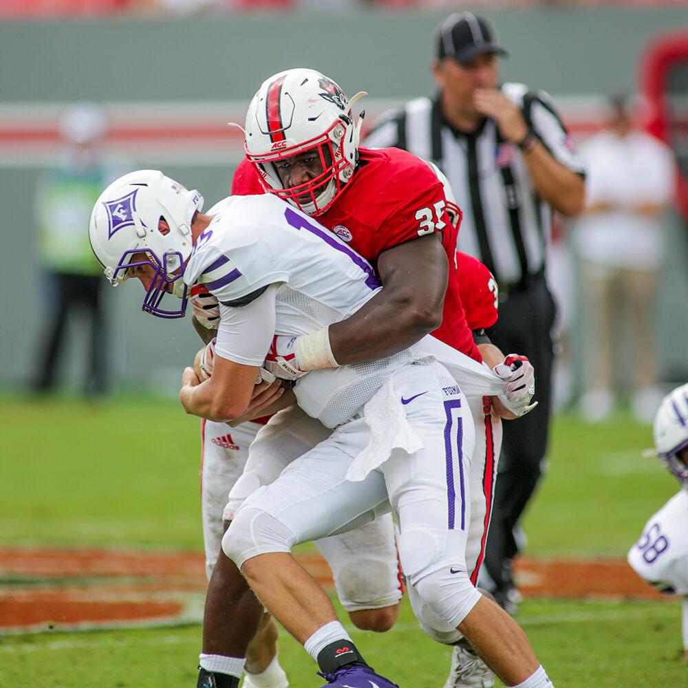 Senior defensive end Kentavius Street comes up with a big 4th-and-1 stop during the 49-16 win over Furman on Saturday, Sept 16, 2017 in Carter-Finley Stadium.