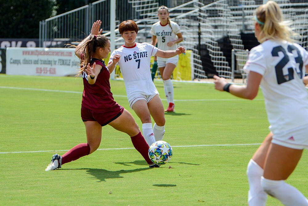 NC State freshman Emika Kawagishi (7) defends an attack near the goal during the NC State Wolfpack's game against the South Carolina Gamecocks at Dail Soccer Field on Saturday, August 29, 2021. The Wolfpack lost the match 2-1 on a last-minute score by the Gamecocks.