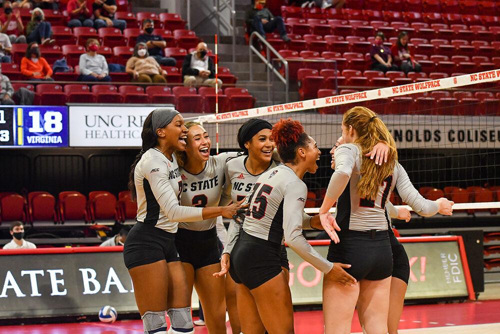 NC State's volleyball team celebrates its win against the Virginia Cavaliers Friday, Sept. 24, 2021 at William Neal Reynolds Coliseum. The Wolfpack beat Virginia 3-1 in its ACC opener.