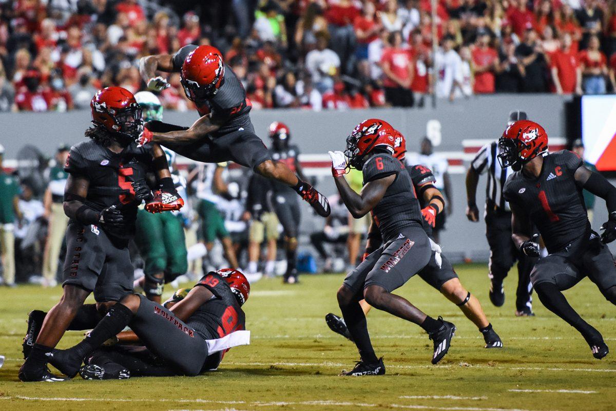 Redshirt graduate corner back Derrek Pitts Jr. leaps over another teammate during a play at Carter-Finley Stadium on Thursday, Sept. 2, 2021. Pitts had three tackles and one TFL. The Wolfpack won 45-0 against the Bulls.