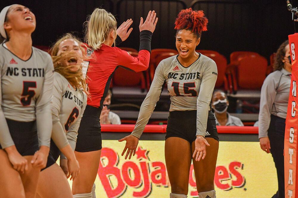 Senior outside hitter Jade Parchment high fives graduate student Kaylee Frazier during the game Friday, Sept. 24, 2021. The Wolfpack beat Virginia 3-1 in its ACC opener.