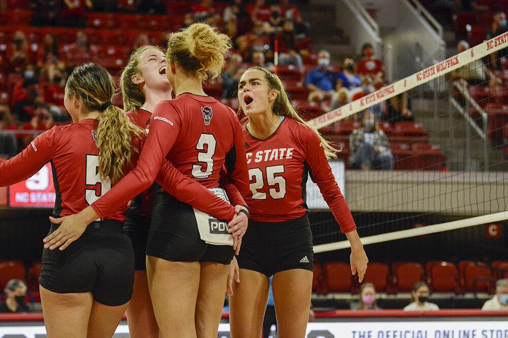 Redshirt junior outside hitter Taylor Rowland and sophmore middle blocker Riley Shaak celebrate with their team during the match against Duke on Sunday, Oct. 24, 2021 in Reynolds Coliseum. The Wolfpack had 60 digs against the Blue Devils during its 3-0 win.