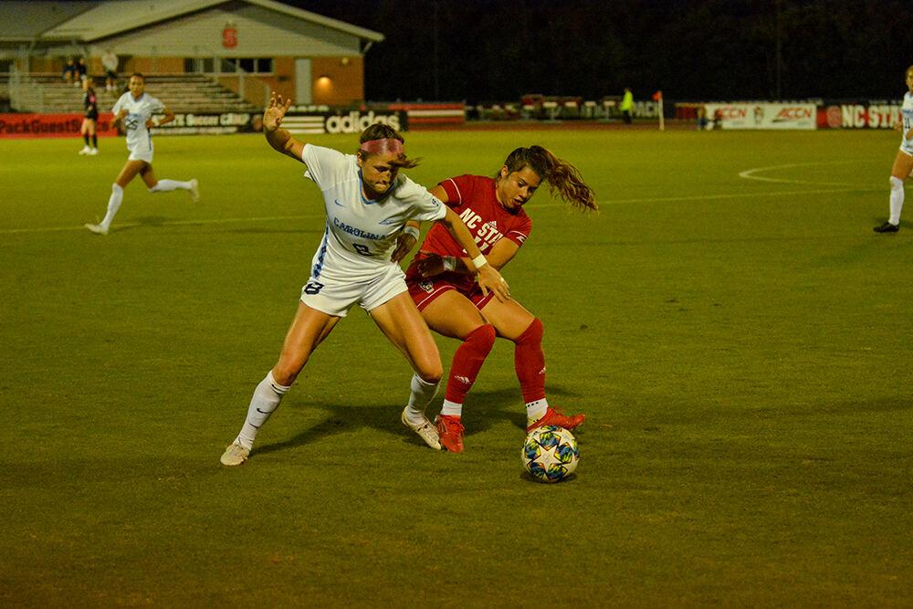 NC State freshman defender Fernanda Soto defends against Tar Heel forward Emily Moxley during the Wolfpack's home soccer match against the North Carolina Tar Heels at Dail Soccer Field on Saturday Oct. 16, 2021. The Wolfpack won the match 1-0. Soto had one shot on goal in 88 minutes.