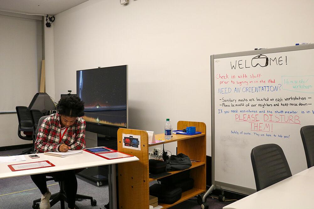 Fourth-year Jaliyah Scott studying industrial engineering and global perspective works at the desk of the virtual reality lab at D.H. Hill Library on Wedneday, Mar. 20, 2019.