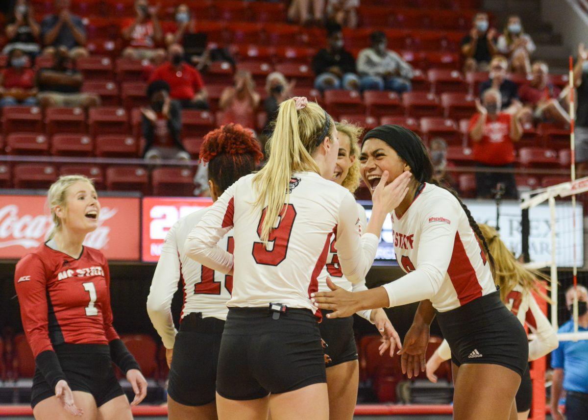 Freshman middle blocker Jada Allen rejoices with her team during the match up against the Georgia Bulldogs on Thursday, Sept. 16, 2021 in Reynolds Coliseum. Allen had 8 kills during NC State's 3-1 win over the Bulldogs.