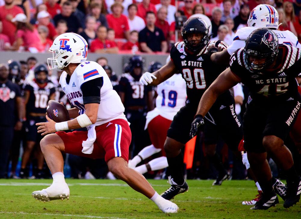 Louisiana Tech quarterback Austin Kendall scrambles away from NC State&#8217;s pressure on Saturday, Oct. 2, 2021 at Carter-Finley Stadium. Kendall went 26-43 for 341 yards, three touchdowns and two interceptions as the Wolfpack won 34-27.