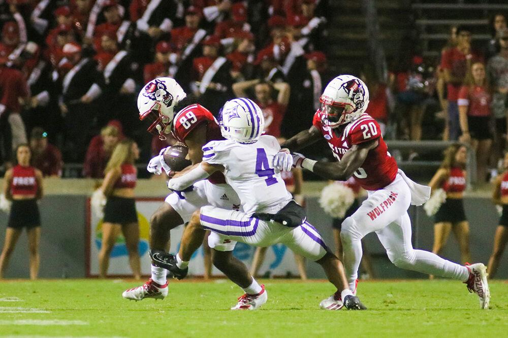 Freshman wide receiver Jakolbe Baldwin get tackled by a Furman Paladin defender during the game against Furman on Saturday, Sept. 18, 2021 at Carter-Finley Stadium. Baldwin had one carry for four yards. The Wolfpack beat the Furman Paladins 45-7.