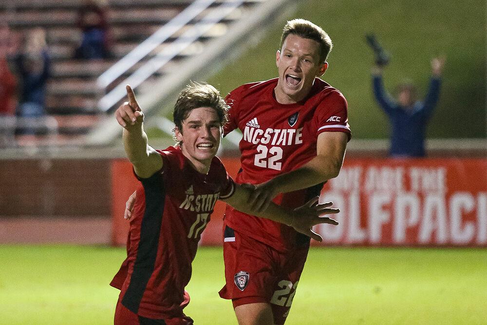 Freshman midfielder Luke Hille and senior midfielder Aidan Foster celebrate after Hille's header scores the golden goal during the game against Boston College. NC State took down Boston College 1-0 in the second overtime period in Dail Soccer Stadium on Friday, Oct. 29, 2021.