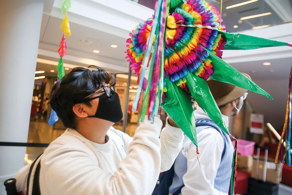 Cristian Mendoza, a first year in engineering, breaks apart a pi&#241;ata after it was mostly empty of candy during the Latinx Heritage Month kickoff event at Talley Student Center on Wednesday, Sept. 15, 2021. "I just wanted a hat," said Mendoza. "It's something all Hispanic kids think about, especially young kids. You just make a hat out of it at the end."