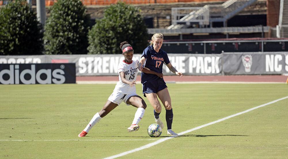 Sophomore forward Jameese Joseph defends against a Virginia player on Sunday, Sept. 26, 2021 at Dail Soccer Field. NC State lost to Virginia with a final score of 2-1.
