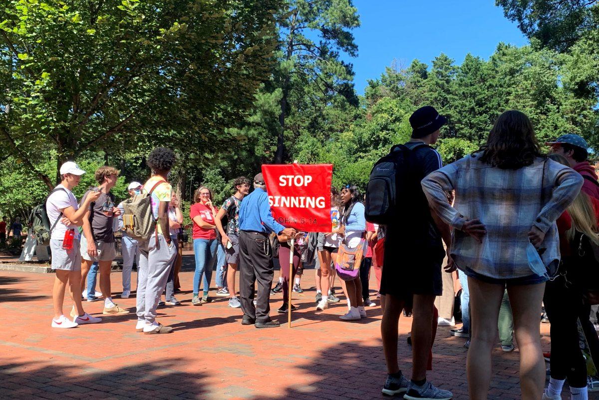 Gary Birdsong is surrounded by students on Sept. 23, 2021 in Wolf Plaza.