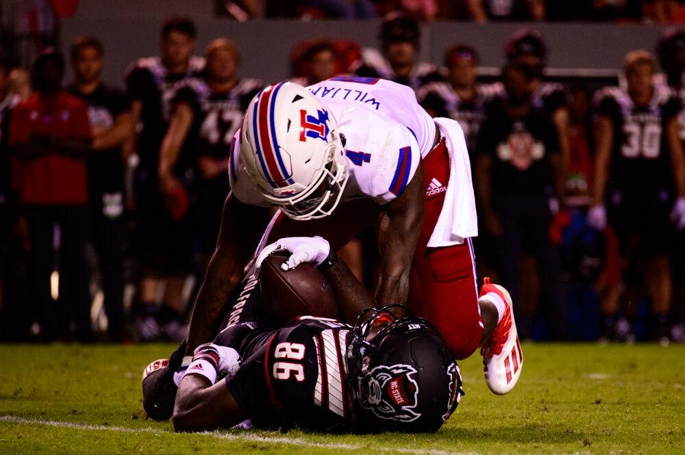 Louisiana Tech defensive back BeeJay Williamson tackles senior wide receiver Emeka Emezie on Saturday, Oct. 2, 2021 at Carter-Finley Stadium. The Wolfpack won 34-27.