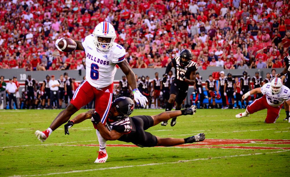 Junior safety Tanner Ingle attempts to tackle Louisiana Tech wide receiver Smoke Harris on Saturday, Oct. 2, 2021 at Carter-Finley Stadium. Ingle made eight tackles as the Wolfpack won 34-27.