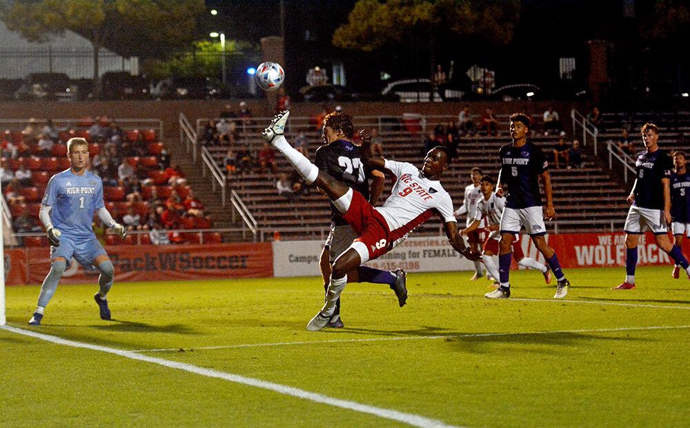Senior forward Kuda Muskwe saves the ball assisting Alex Hernandez for NC State's second goal during the game against High Point on Tuesday, Oct. 12, 2021 at Dail Soccer Field. Muskwe had two goals and one assist in the Wolfpack's 4-0 win over the Panthers.