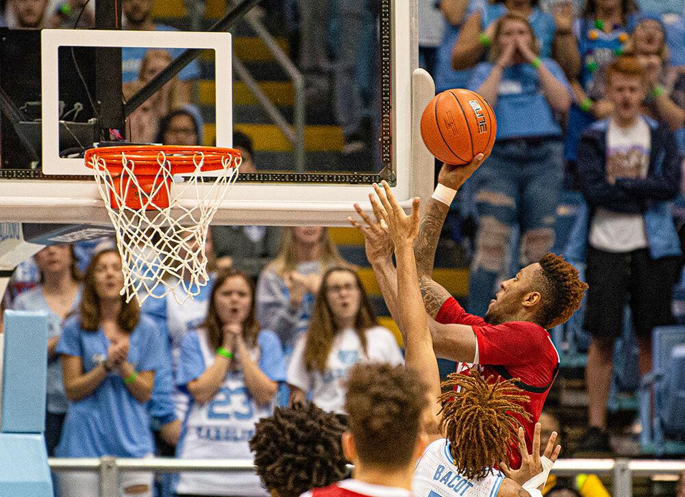 Redshirt freshman forward Manny Bates attacks the basket against North Carolina forward Armando Bacot on Tuesday, Feb. 25, 2020 at the Dean E. Smith Center. Bates grabbed five rebounds as the Wolfpack lost 85-79.