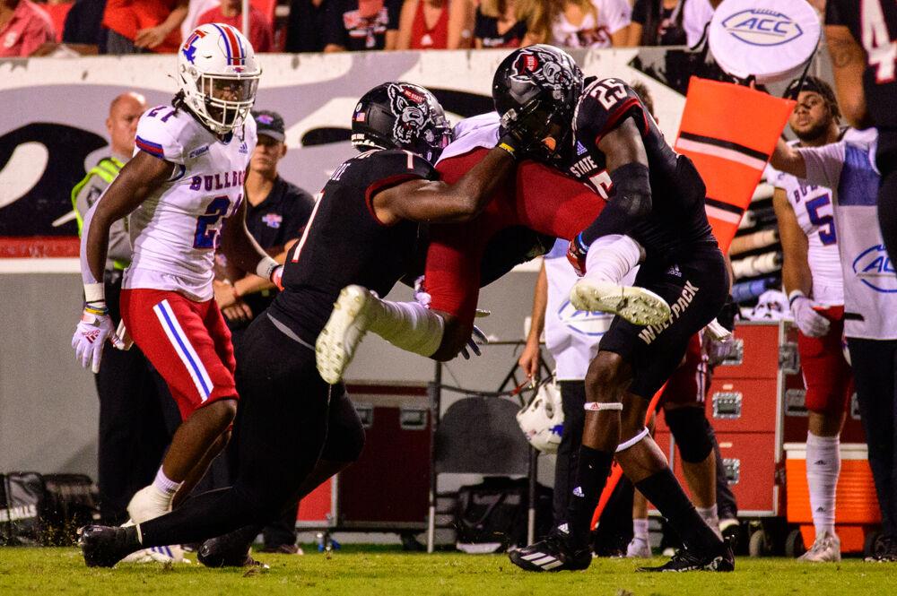 Redshirt junior linebacker Isaiah Moore and redshirt freshman cornerback Shyheim Battle combine for a tackle against Louisiana Tech on Saturday, Oct. 2, 2021 at Carter-Finley Stadium. Moore had 10 tackles and a sack while Battle totaled four tackles and two pass breakups as the Wolfpack won 34-27.