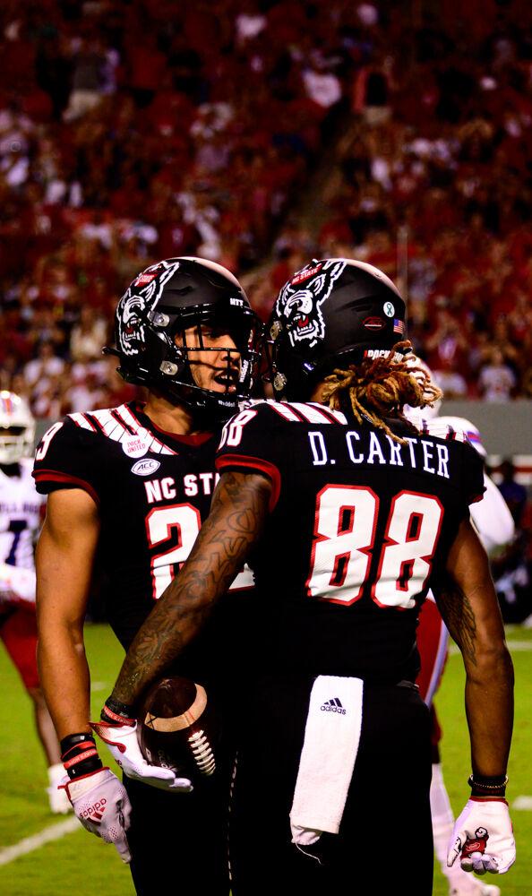 Redshirt sophomore wide receiver Devin Carter celebrates with his teammate during the game against Louisiana Tech on Saturday, Oct. 2, 2021 at Carter-Finley Stadium. The Wolfpack won 34-27.