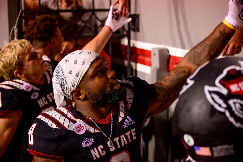 Junior running back Ricky Person Jr. greets fans after the win over Louisiana Tech on Saturday, Oct. 2, 2021 at Carter-Finley Stadium. Person had 15 carries for 90 yards and a touchdown as the Wolfpack won 34-27.