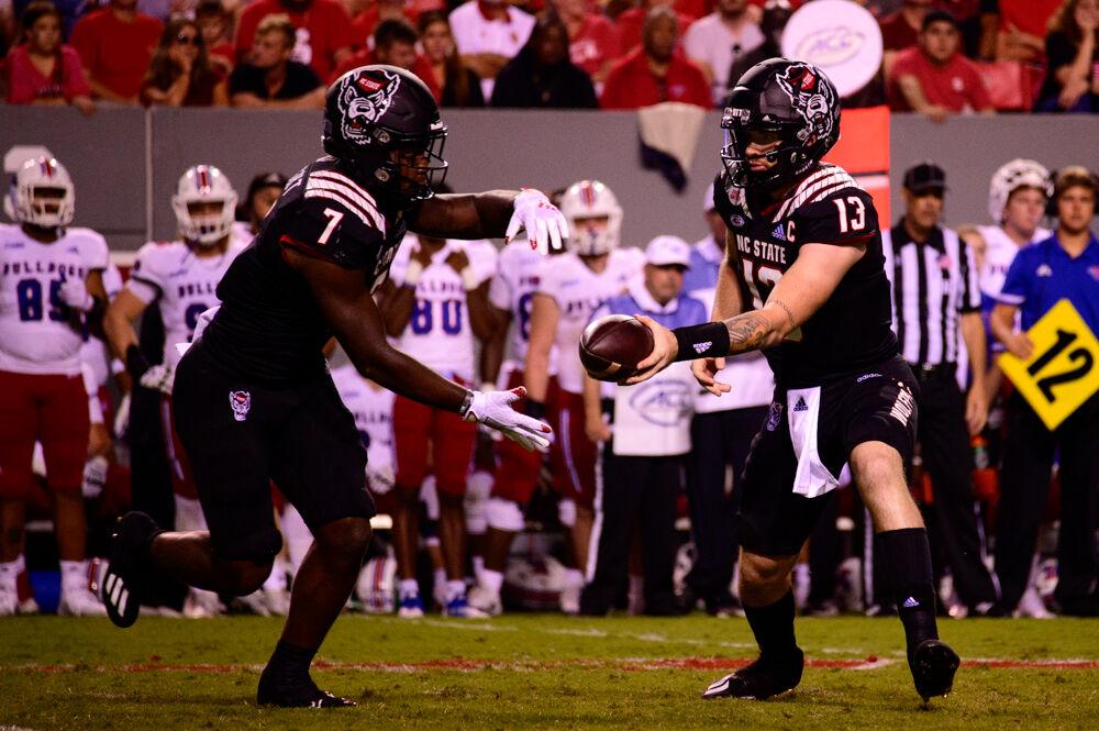 Redshirt sophomore quarterback Devin Leary hands the ball off to sophomore running back Zonovan Knight on Saturday, Oct. 2, 2021 at Carter-Finley Stadium. Knight had 13 carries for 85 yards and a touchdown as the Wolfpack beat Louisiana Tech 34-27.