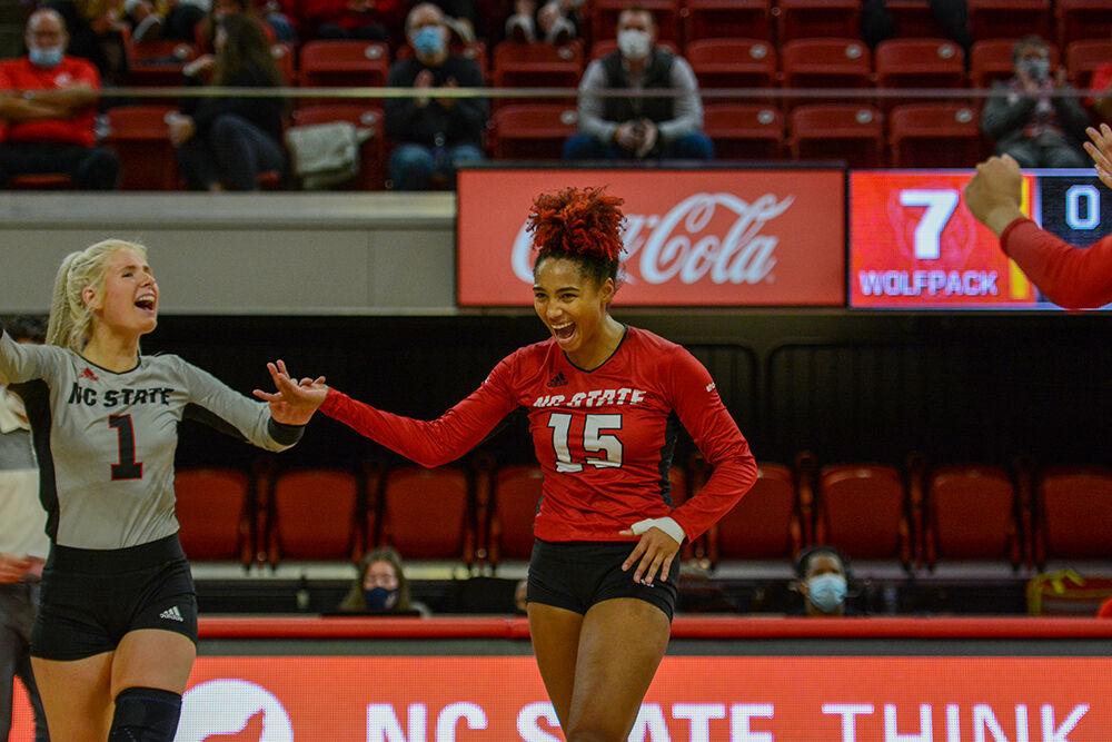 Graduate student libero Kaylee Frazier and senior outside hitter Jade Parchment share a high five during NC State's match against Notre Dame on Sunday, Nov. 7, 2021 in Reynolds Coliseum. Frazier and Parchment were among the Wolfpack leaders for assists against the Irish, with 5 and 3 assits repsectively, during the 3-2 win.