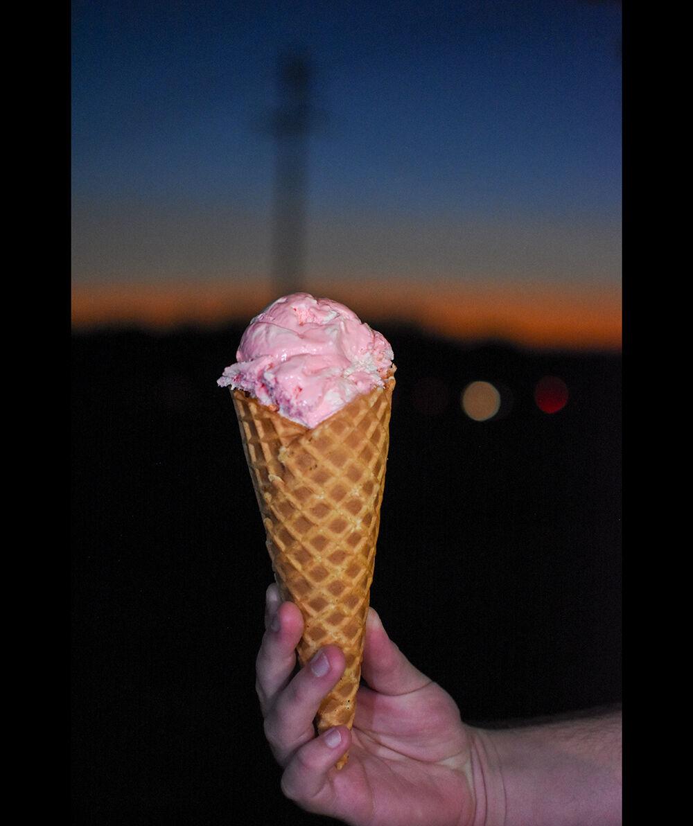 An ice cream cone is held at the Howling Cow Creamery on Tuesday, Nov. 16, 2021. Icing on the Cake is Howling Cow&#8217;s newest limited edition flavor.